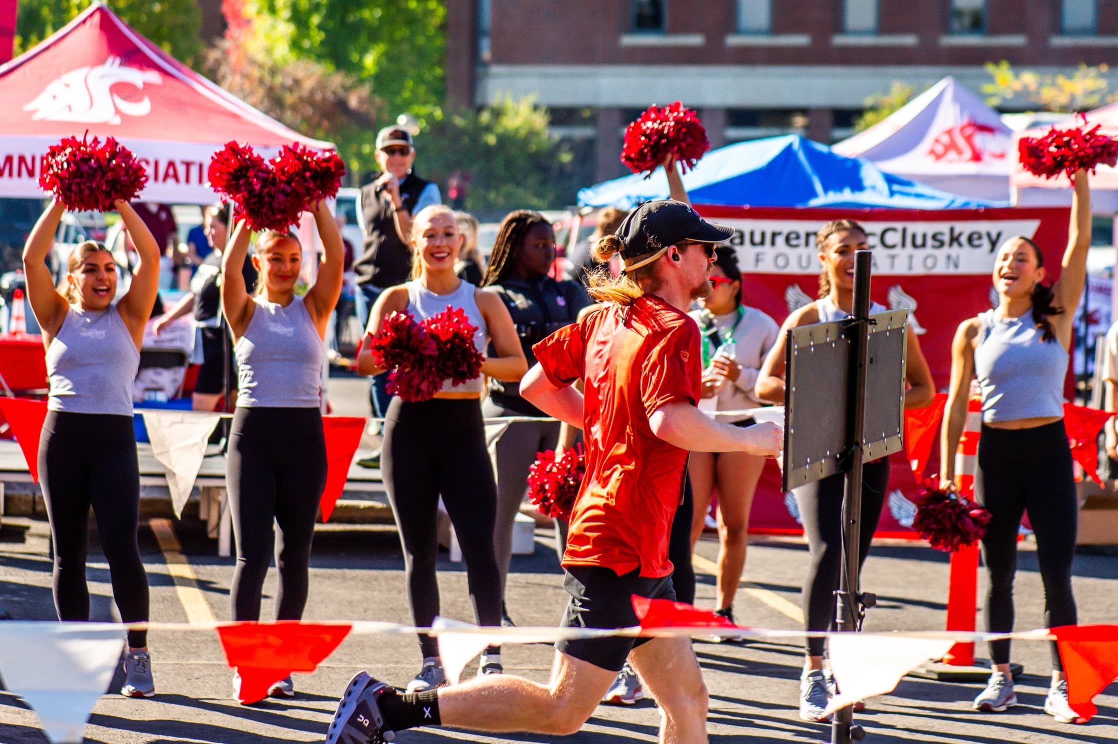 Participant running past Washington State University Cheer team at 2024 Race for Campus Safety / Lauren's Lap
