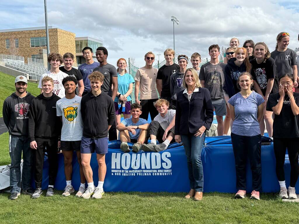 Foundation supports amateur athletics at Pullman High with donation for Pole Vault Mat 5 Jill McCluskey with Pullman Track team in front of pole vault mat