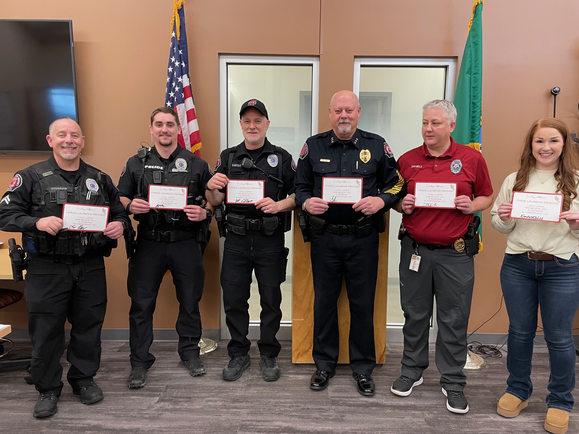 Campus Safety Score Blogpost Featured Image. Washington State University Police holding signed "Lauren's Promise" cards: I will listen and believe you, if you are being threatened."