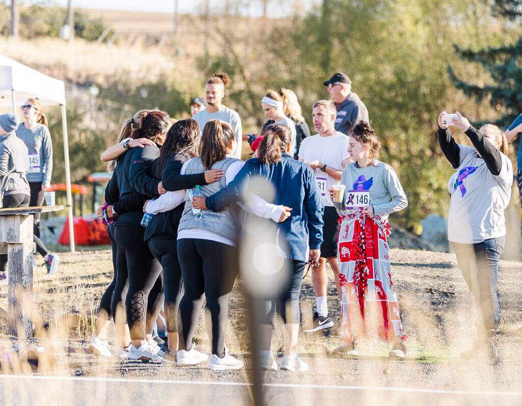 Go Beyond the Finish Line at the 2025 Race for Campus Safety 1 Participants at Race for Campus Safety around wheat field hugging in photo from 2021.